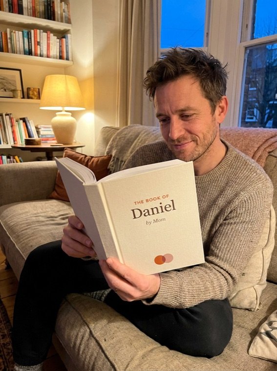 A son reading The Book of Daniel, by Mom